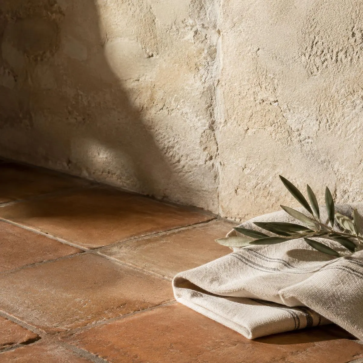 Terracotta tiles, limestone and folded linen