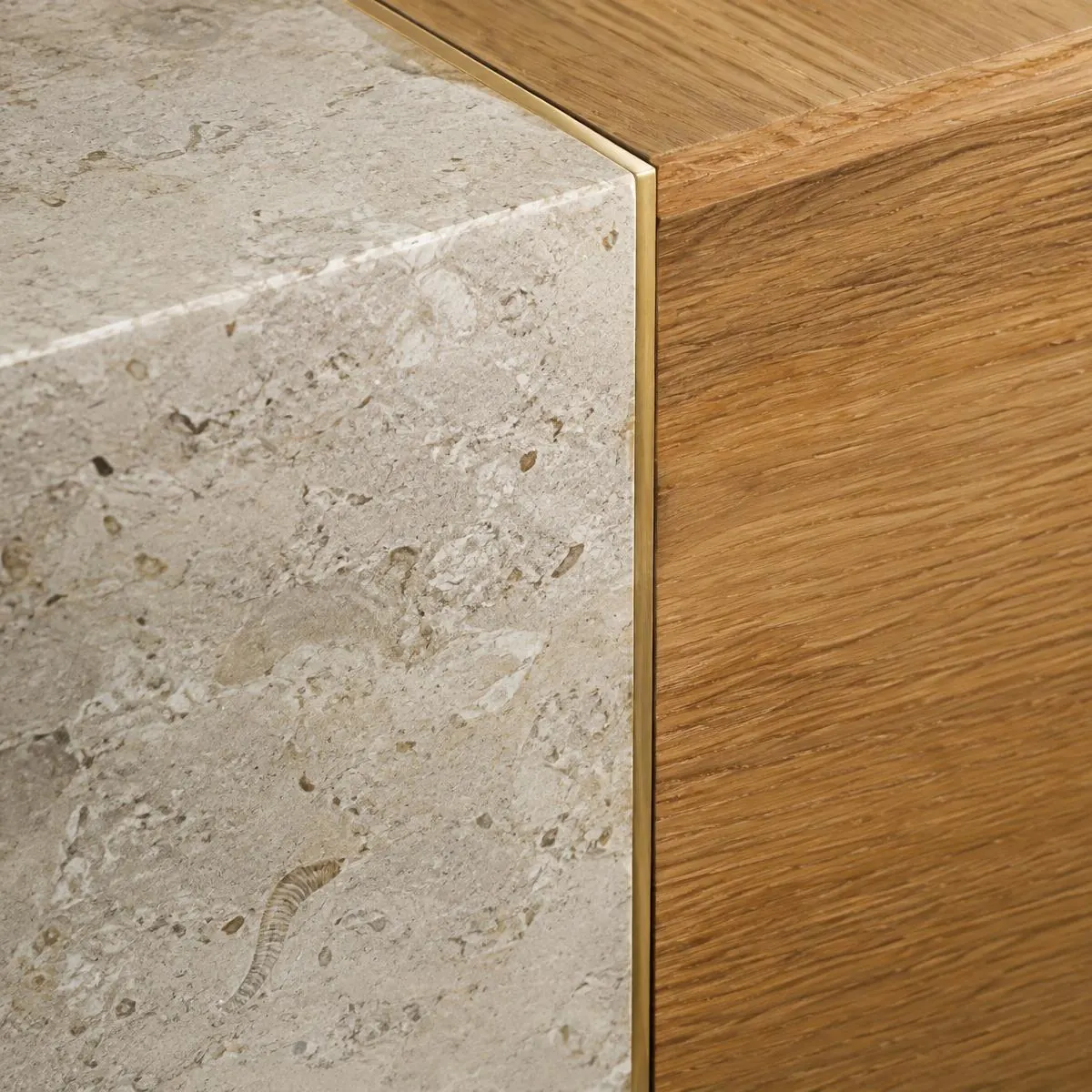 Limestone meeting oak with a brass reveal