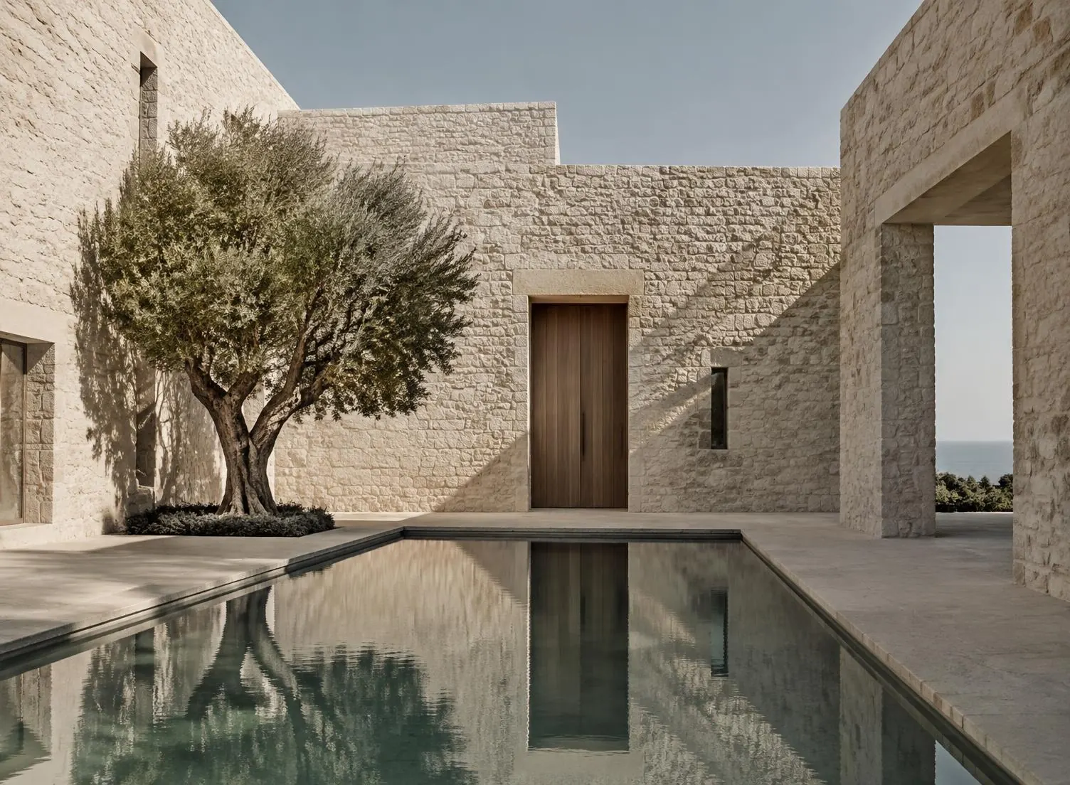 Pool courtyard framed by limestone walls